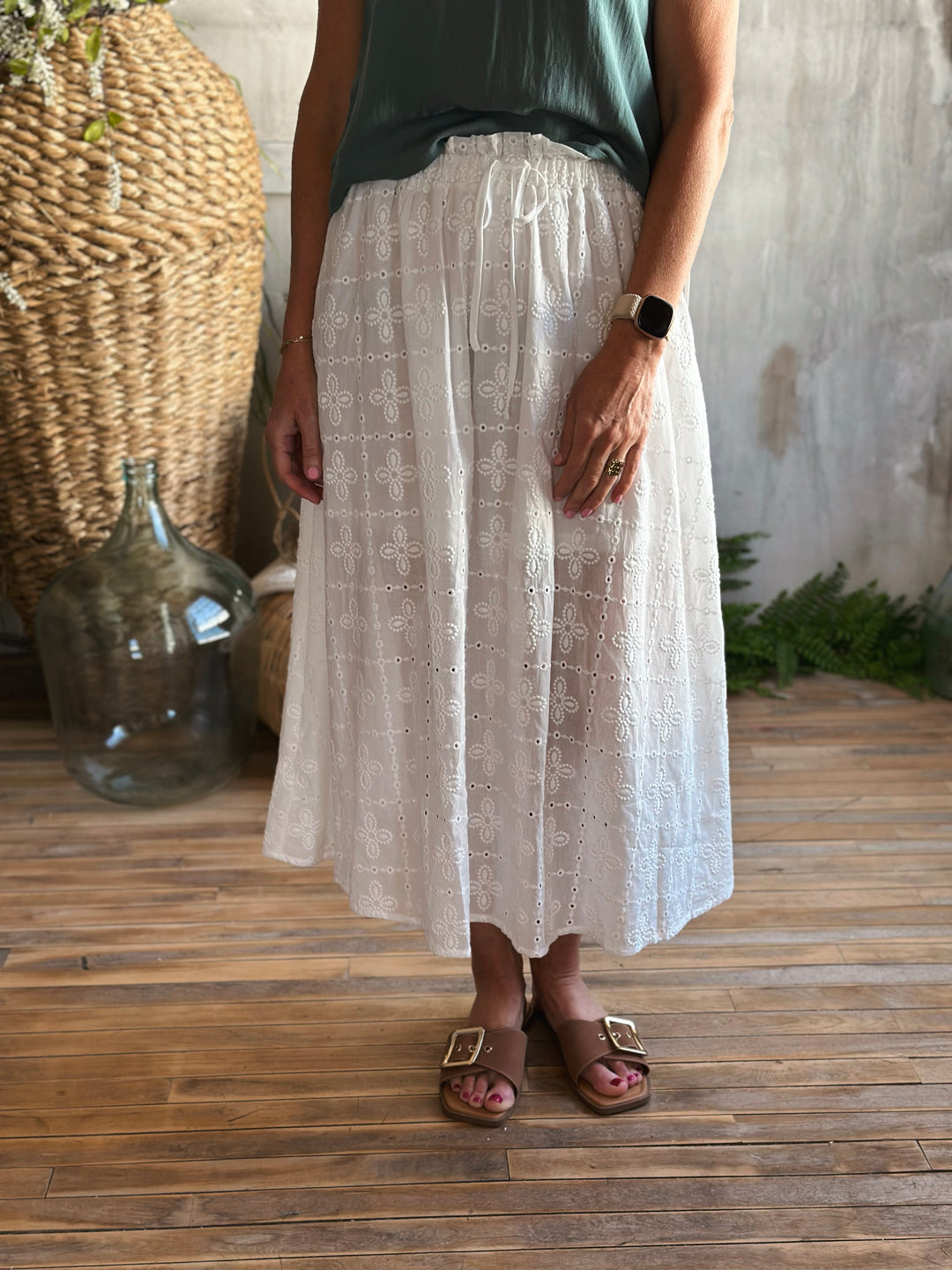 front view white eyelet midi skirt,  Featuring a high elastic waist with a front tie drawstring, delicate ruffle trim, and a classic eyelet pattern.