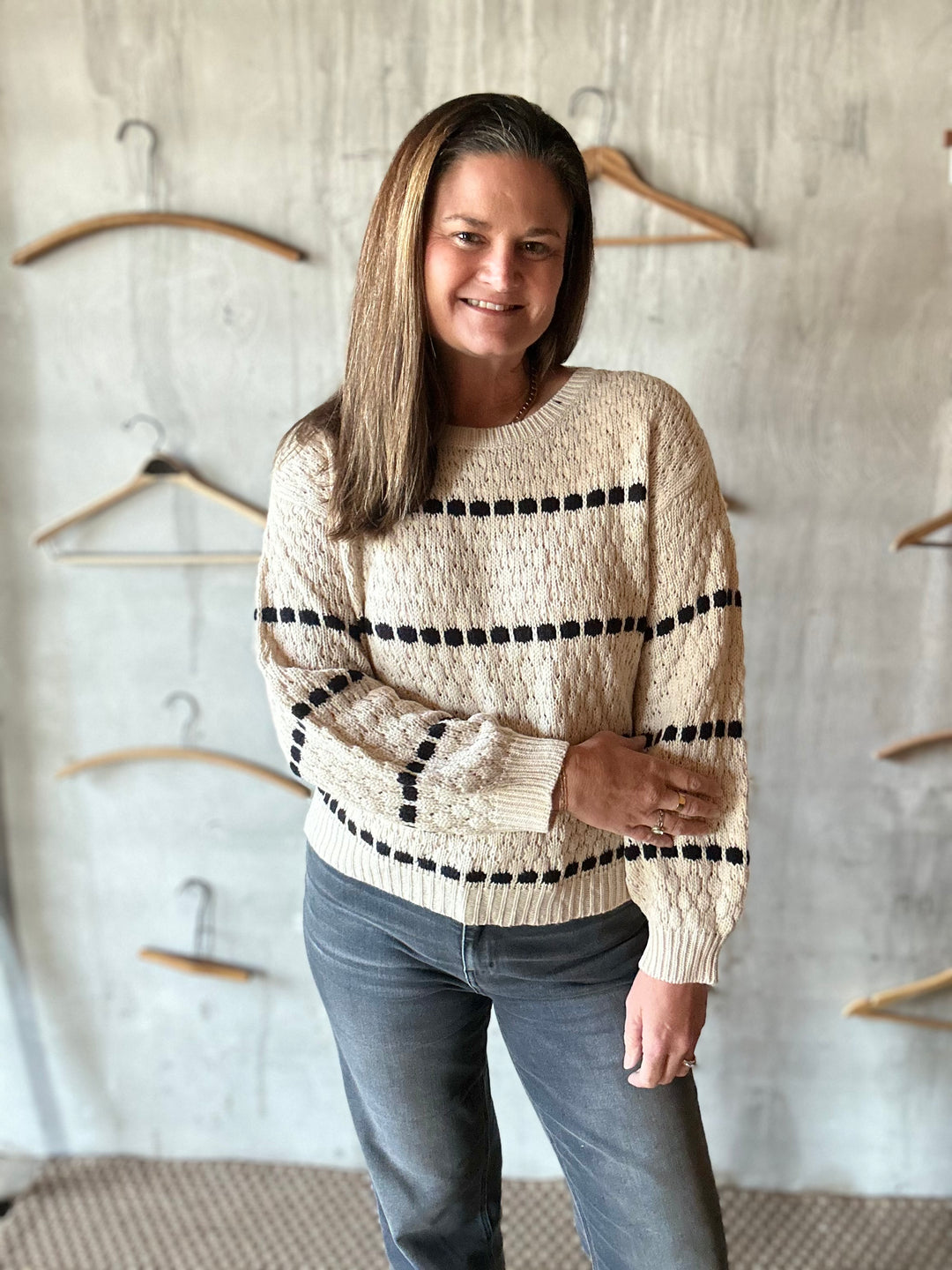 Cream sweater with rows of black bobble stripes, front view