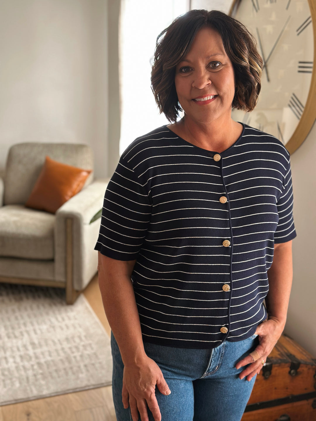 Woman wearing a striped shirt in a living room setting