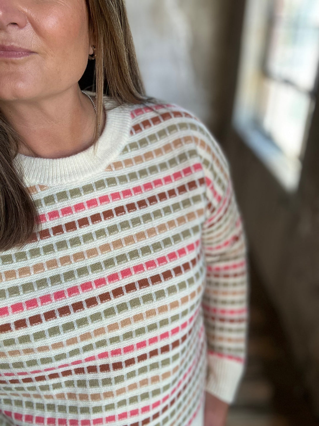 Detail of a cream striped sweater&