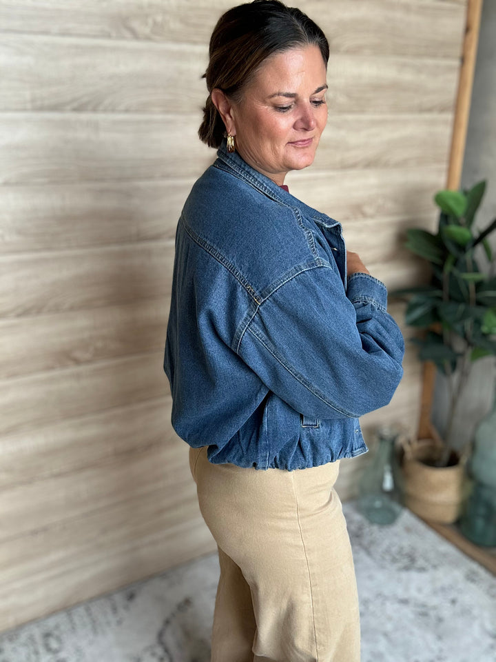 A woman wearing a puffy blue denim jacket.
