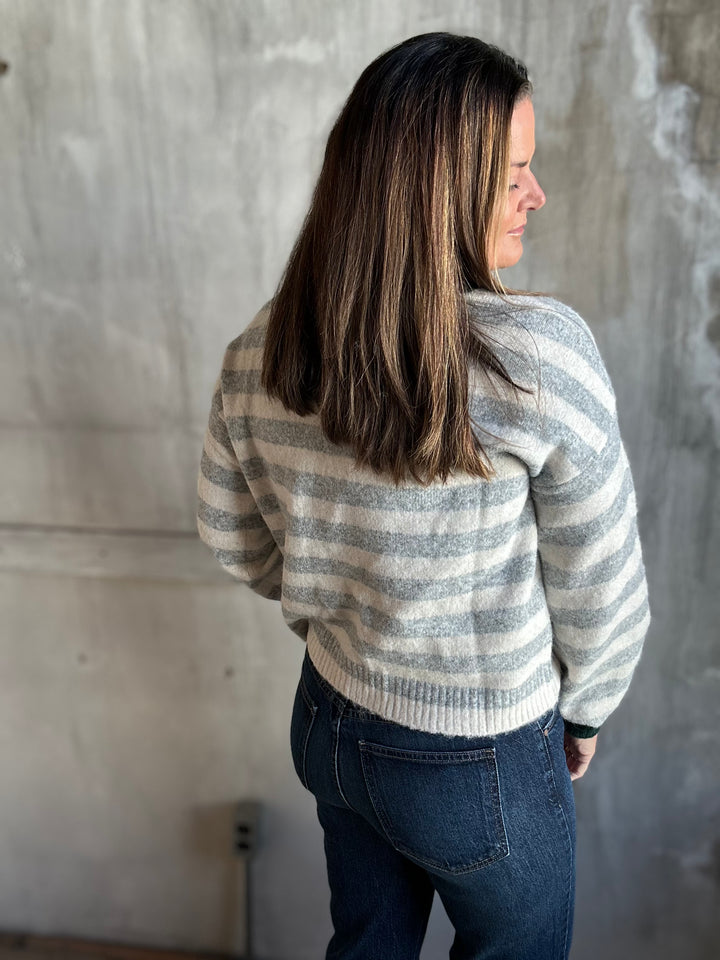 Back view of a gray and cream striped crewneck sweater