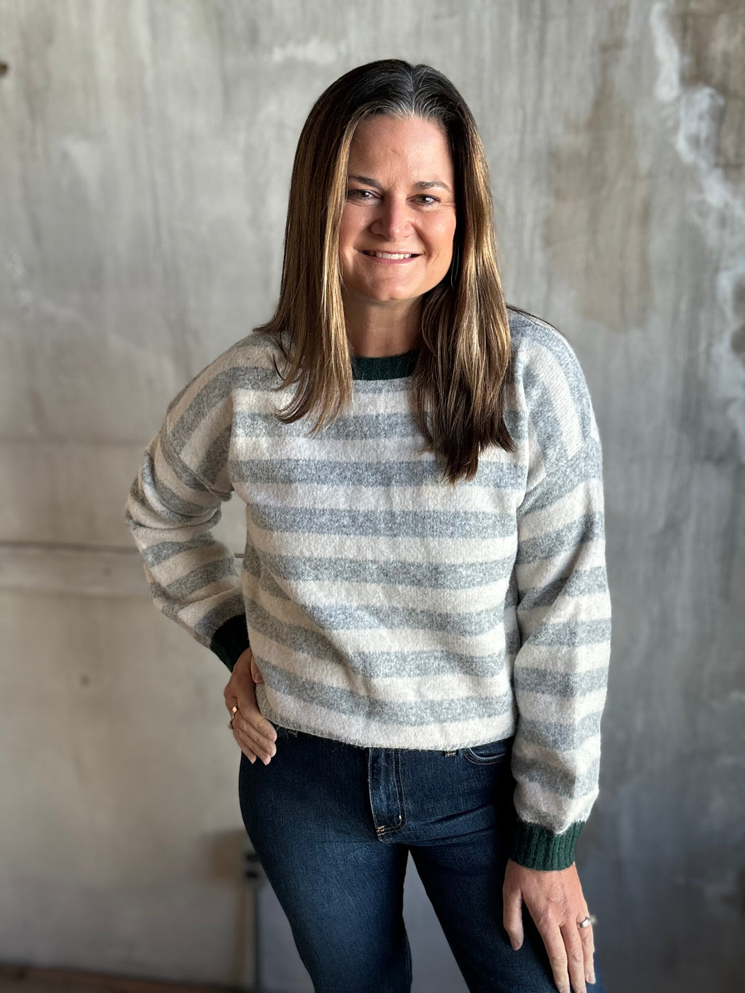 Gray and cream striped sweater with contrast neckline, styled with dark jeans