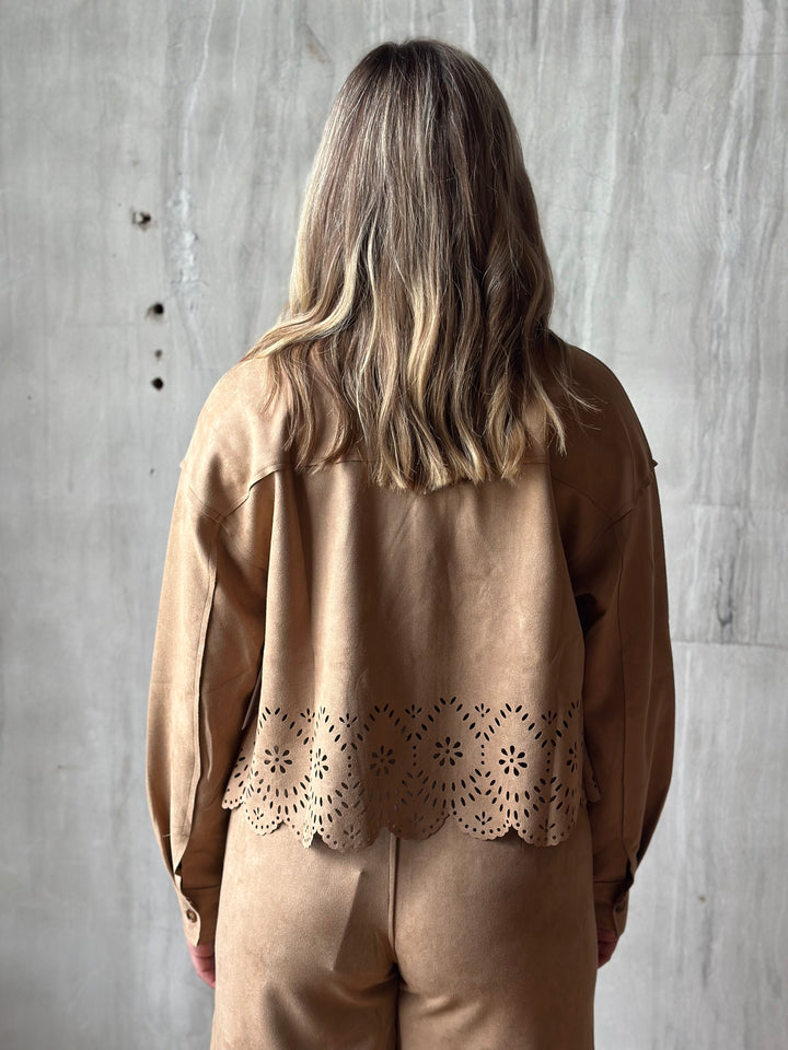 Back view of a tan suede-look shirt jacket with a laser-cut hem