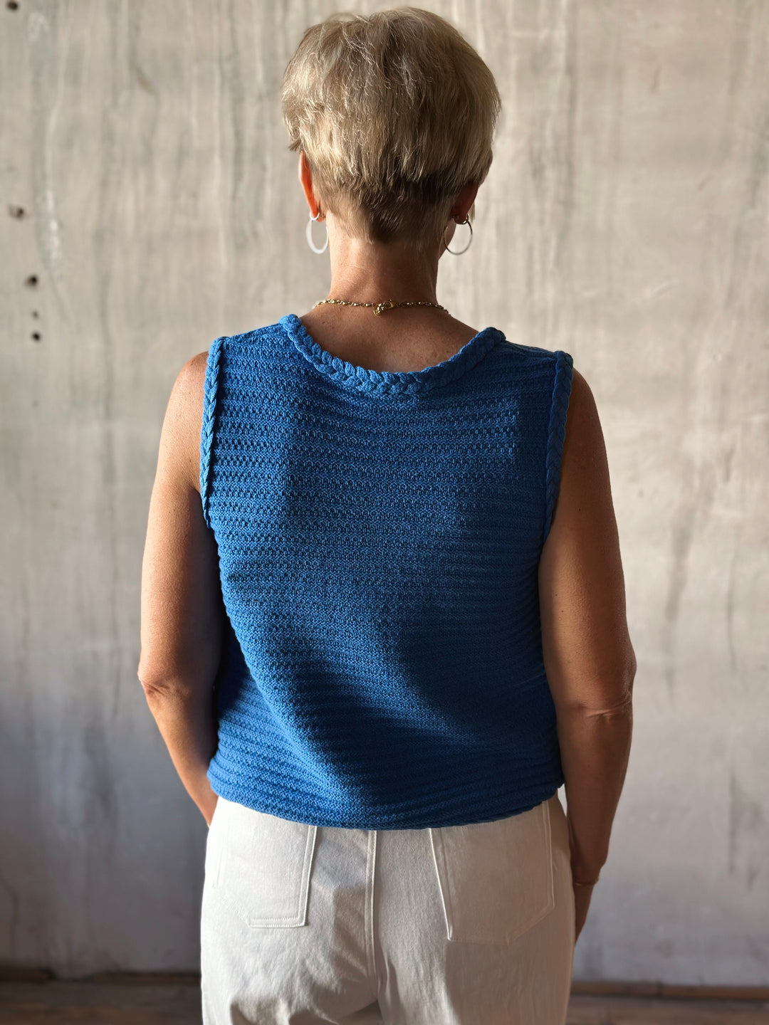 back view solid blue sleeveless sweater knit vest. 