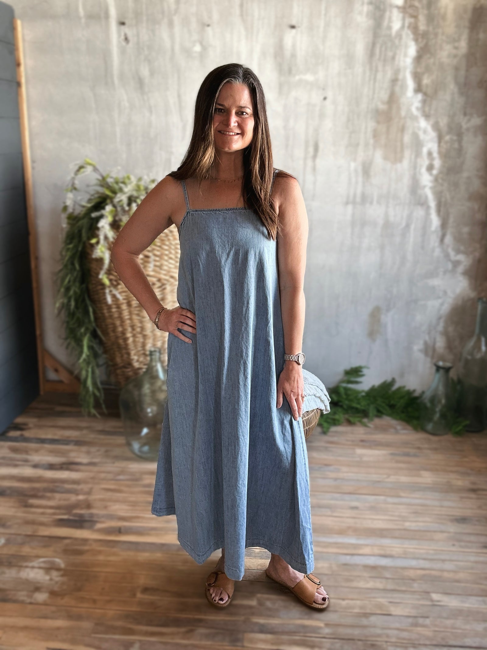 Front view of model wearing long denim maxi dress with spaghetti straps