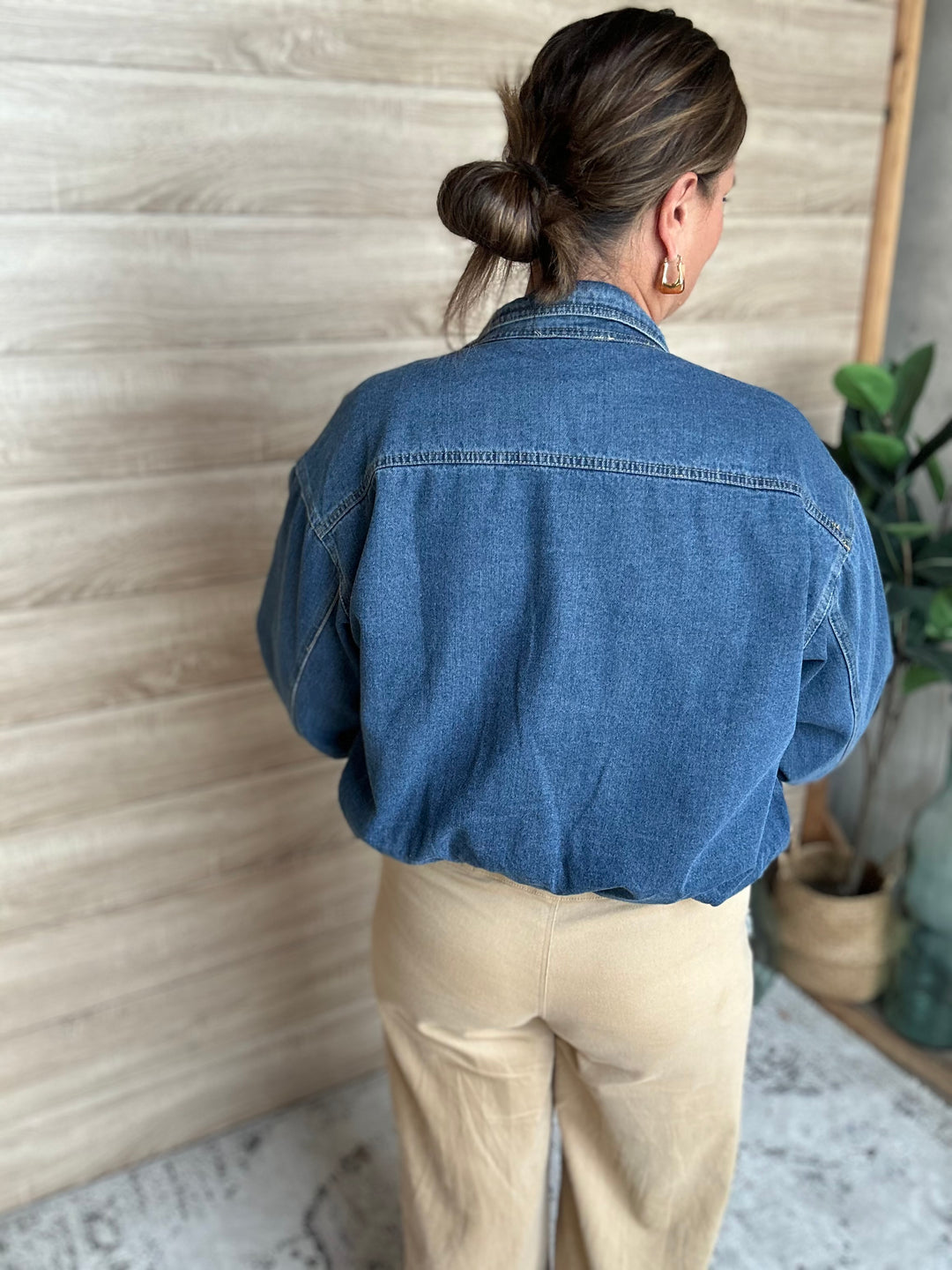 A woman wearing a puffy blue denim jacket.