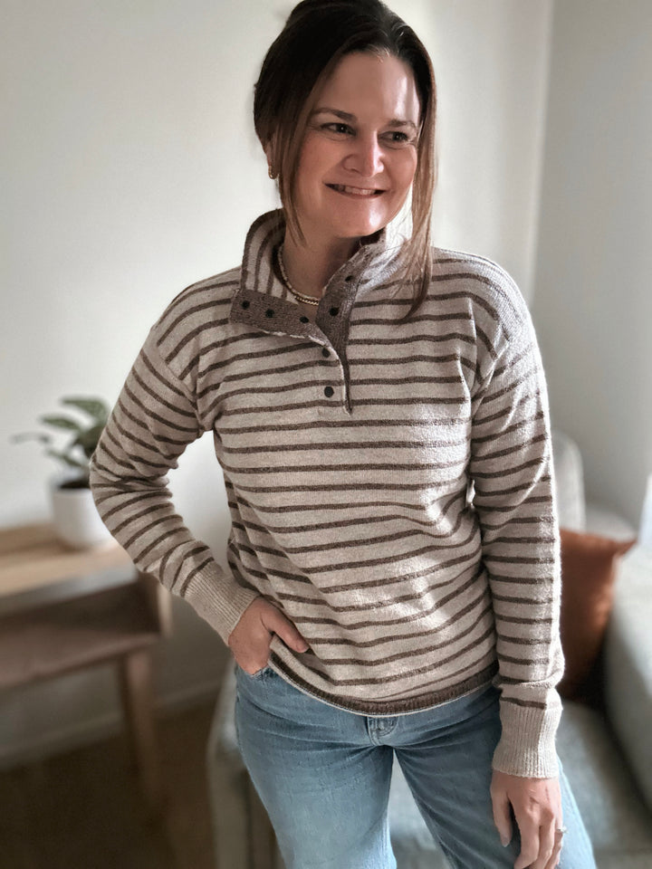 Woman wearing a striped sweater in a home setting