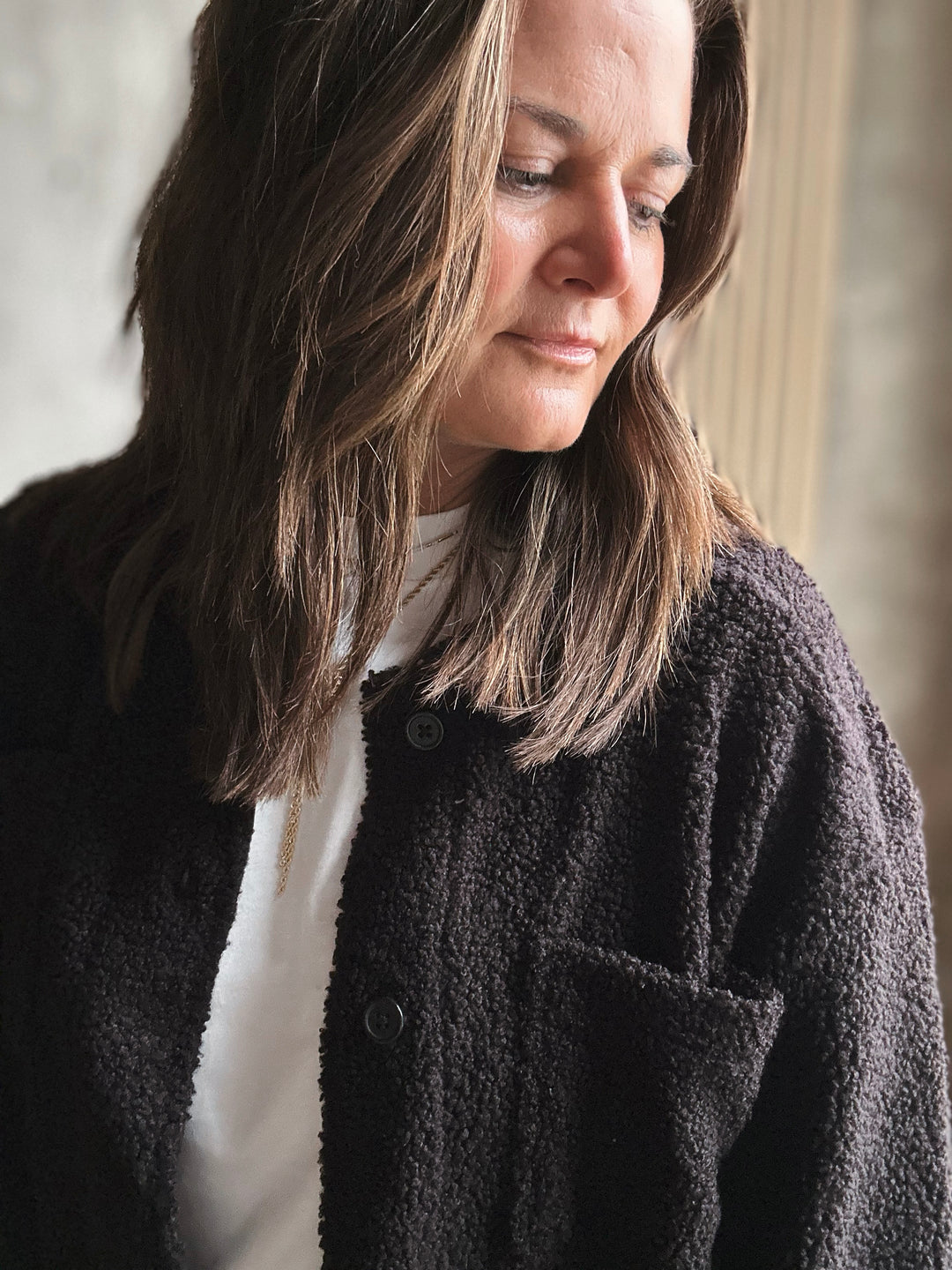 Woman wearing a black jacket with a blurred background