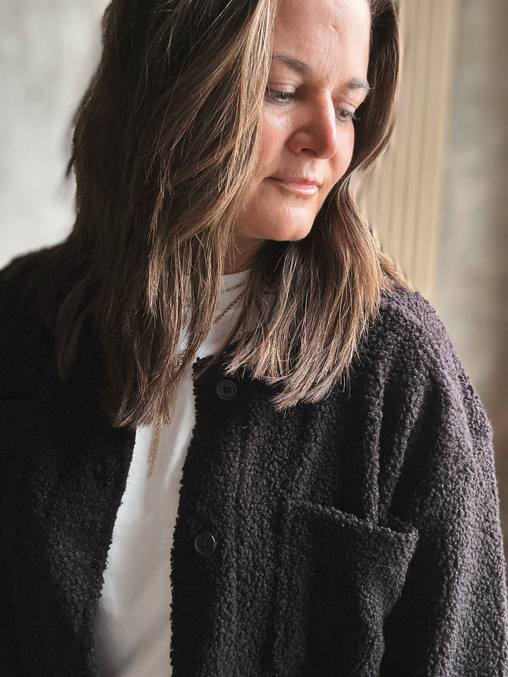 Woman wearing a black jacket with a blurred background