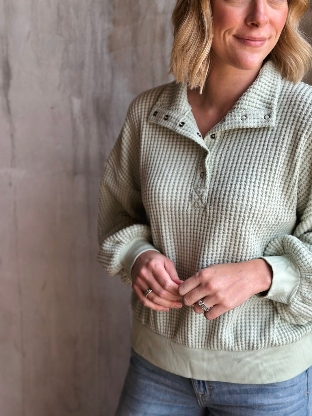 Woman wearing a checkered shirt against a plain background