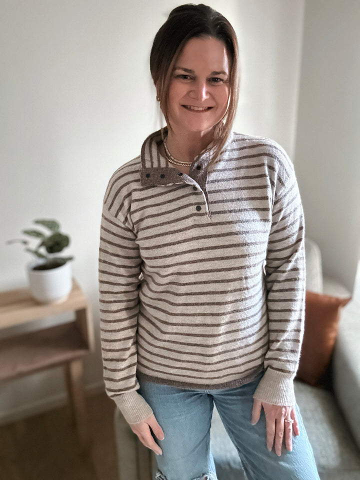 Woman wearing a striped sweater in a home setting