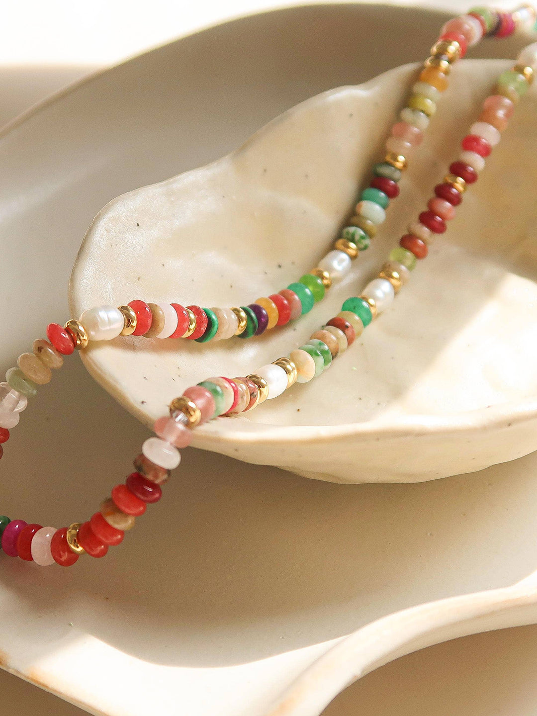 Colorful beaded necklace on a white shell