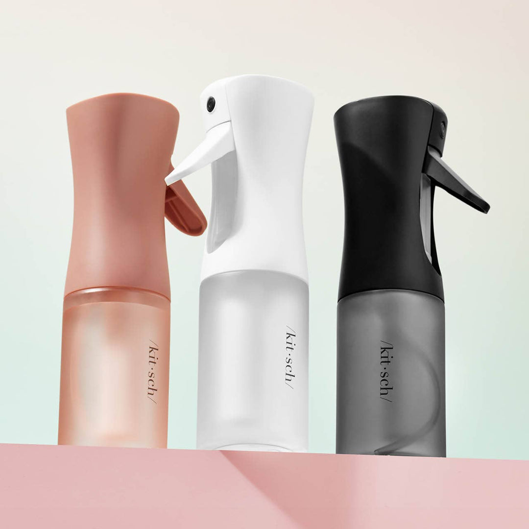 Three spray bottles in different colors with 'kitsch' branding on a light background