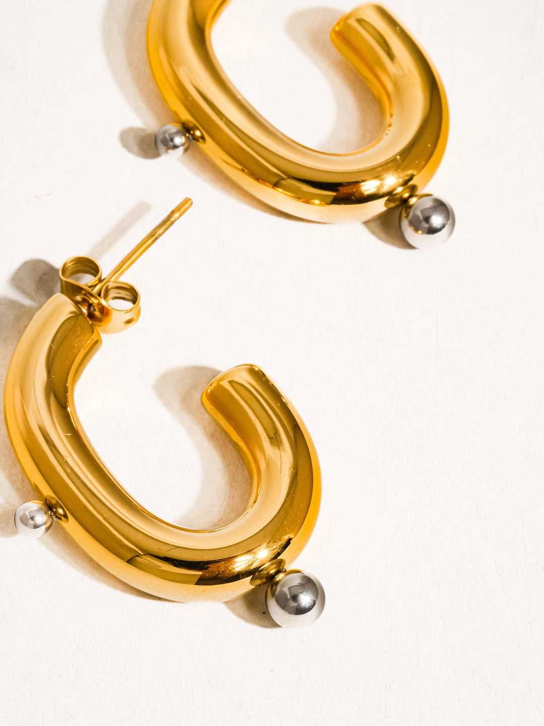 Gold hoop earrings on a white background
