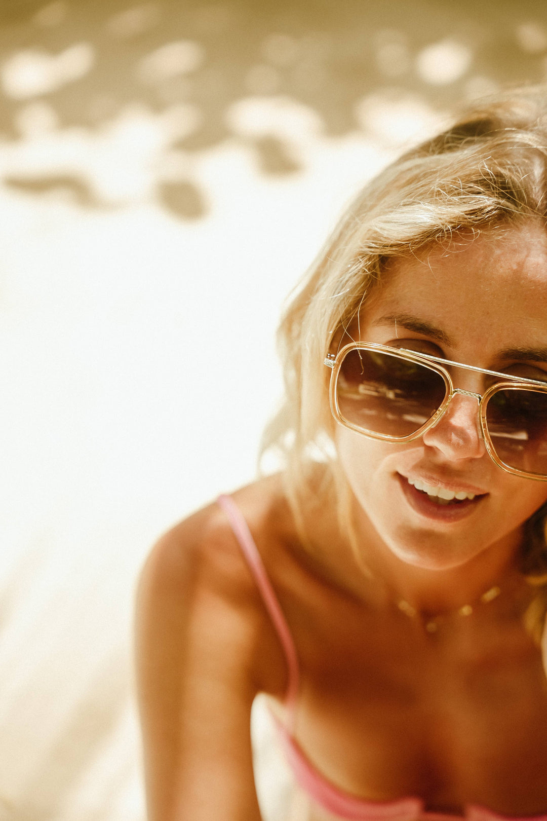 Woman wearing sunglasses with a blurred natural background