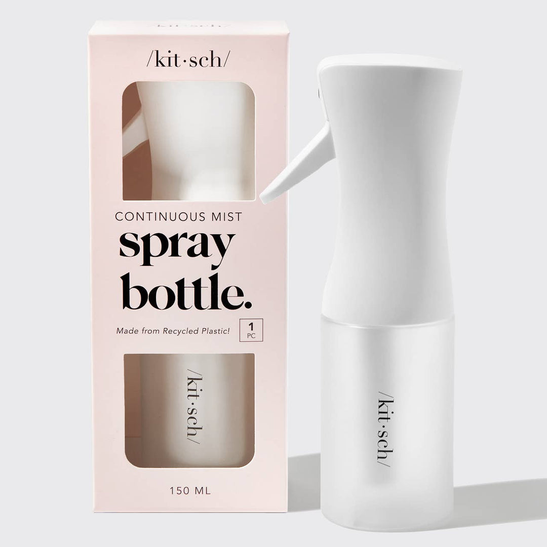 White spray bottle with 'kitsch' branding next to its packaging on a light gray background