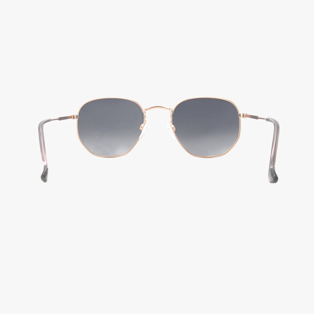 Sunglasses with gold frame and gray gradient lenses on a white background