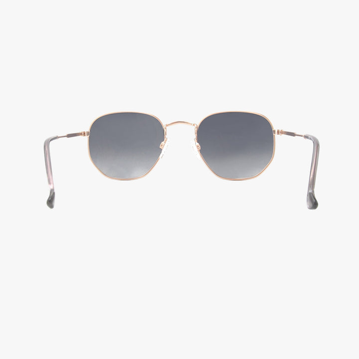Sunglasses with gold frame and gray gradient lenses on a white background